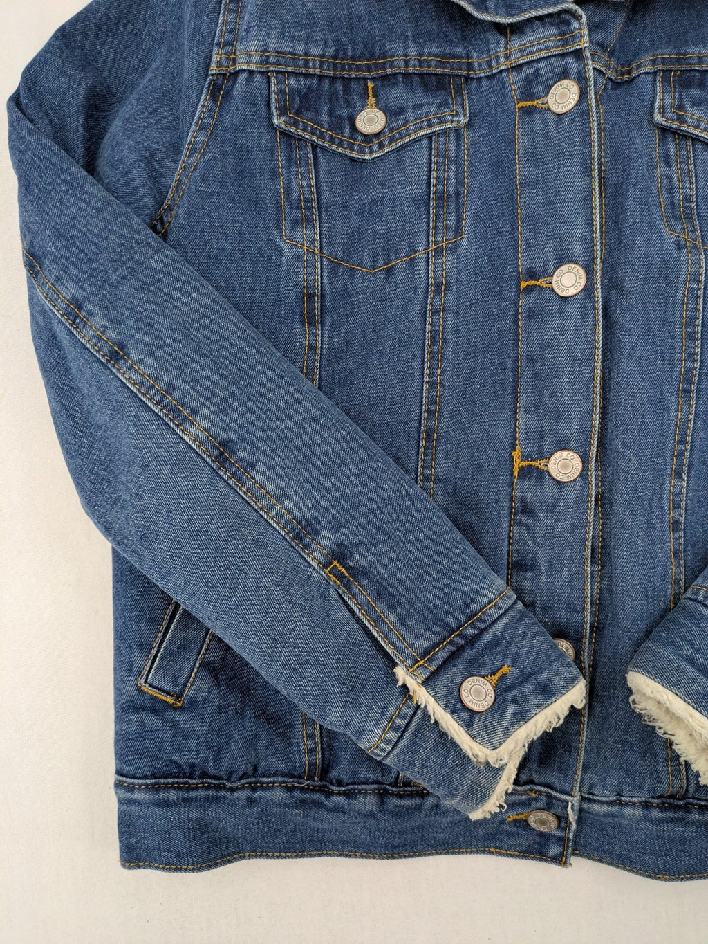 Denim & Co. blue jacket with cream Sherpa lining, button closure, and pockets.