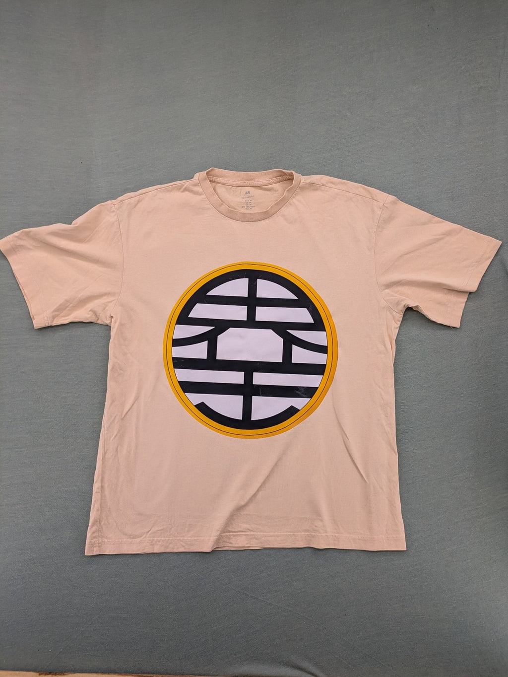 Dragon Ball Z beige t-shirt relaxed fit featuring Goku Go kanji symbol.