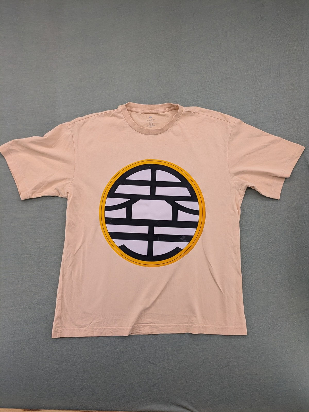 Dragon Ball Z beige t-shirt relaxed fit featuring Goku Go kanji symbol.