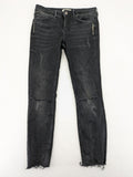 Zara Woman black skinny jeans with distressed details, silver studs, and frayed hem.