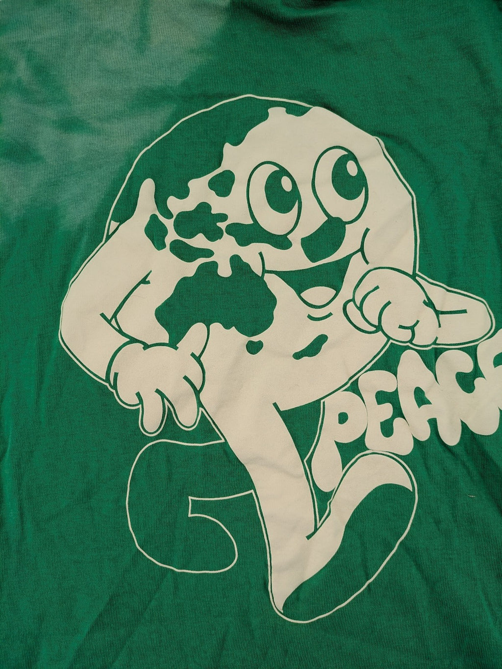 Myla green graphic t-shirt with large peace earth print and front pocket design.