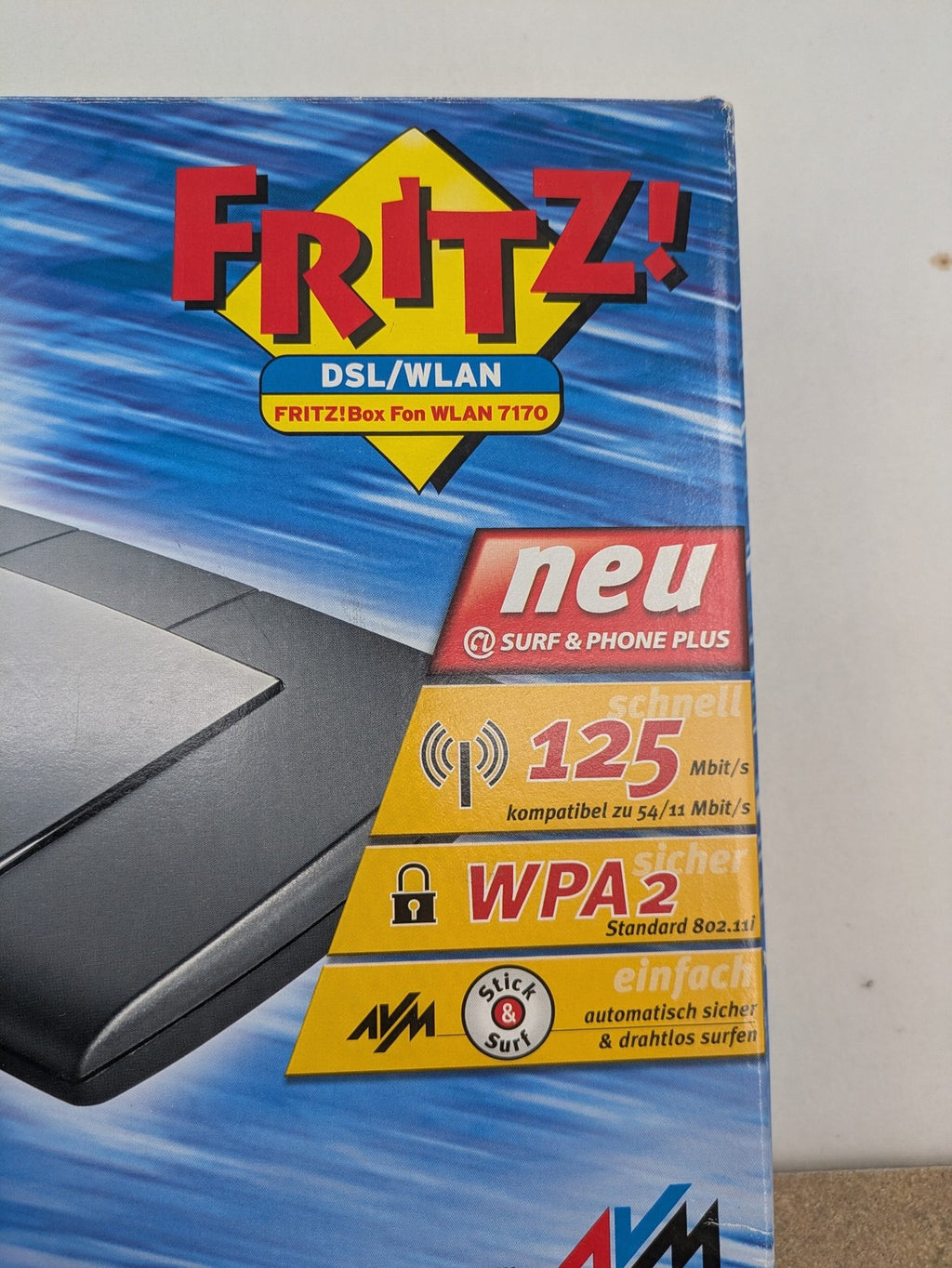 AVM wireless router black grey yellow with logo and integrated DSL modem features.