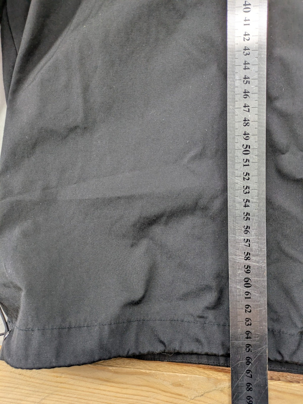 Hypnotism grey windbreaker jacket with hood, snap buttons, and zip closure.