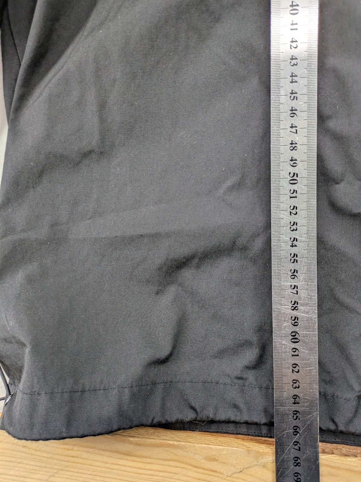 Hypnotism grey windbreaker jacket with hood, snap buttons, and zip closure.