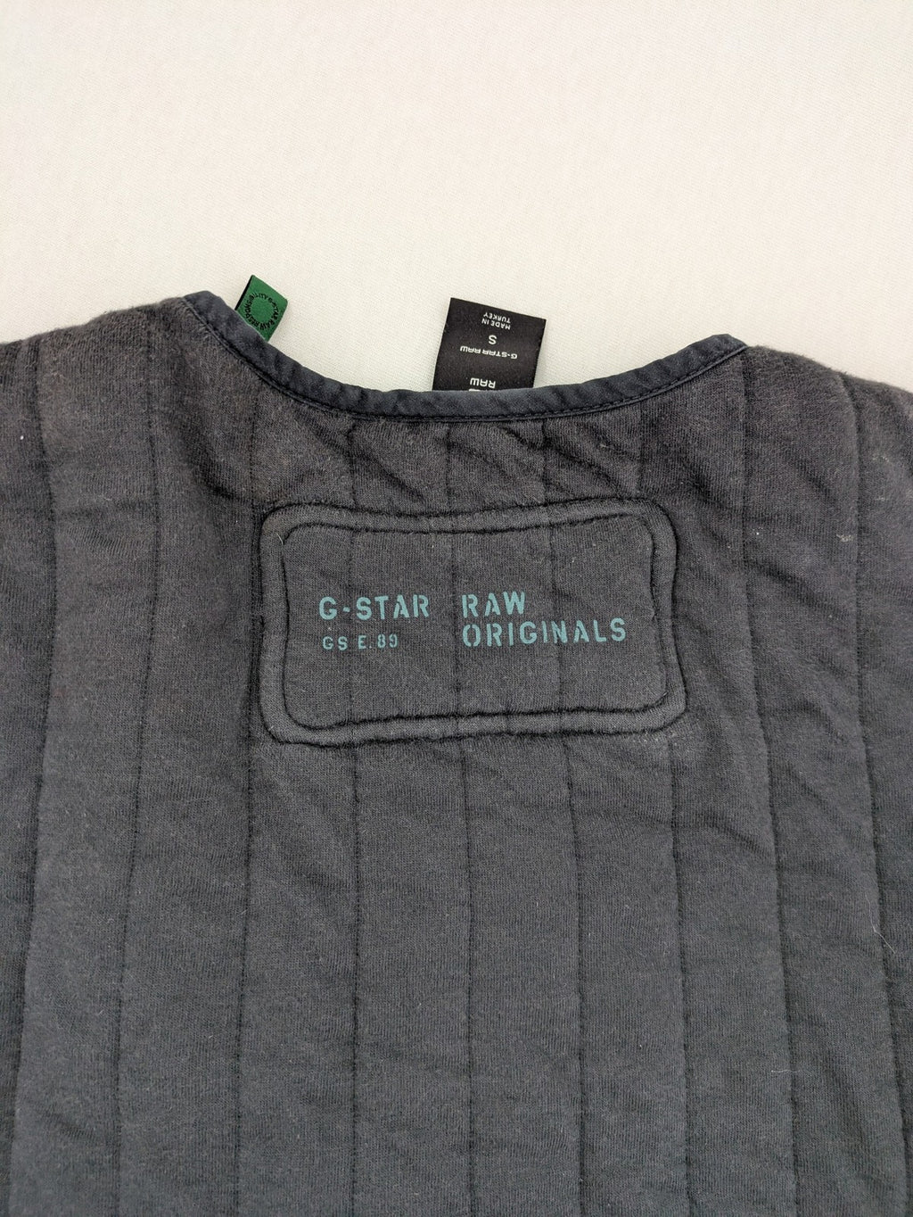 G-Star Raw grey quilted jacket with button closure and adjustable drawstring hem.