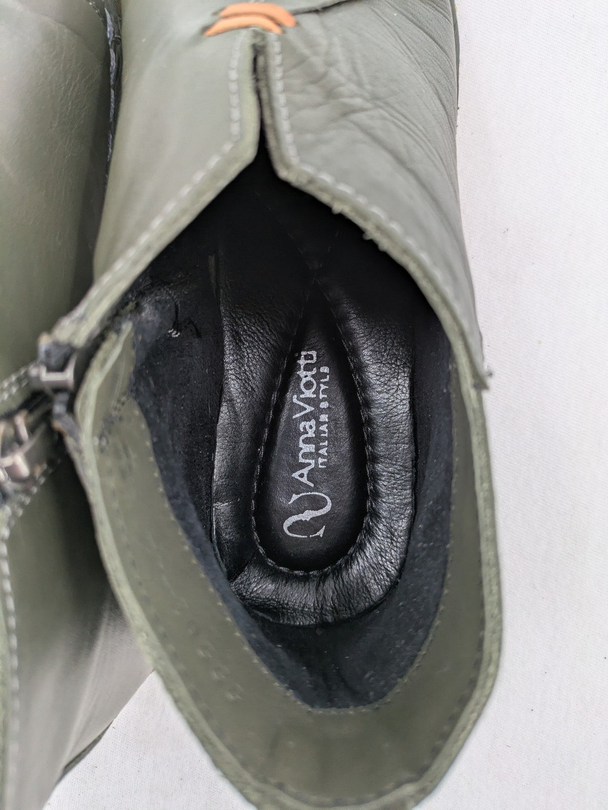 ALS green leather booties with side zipper and decorative stitching.