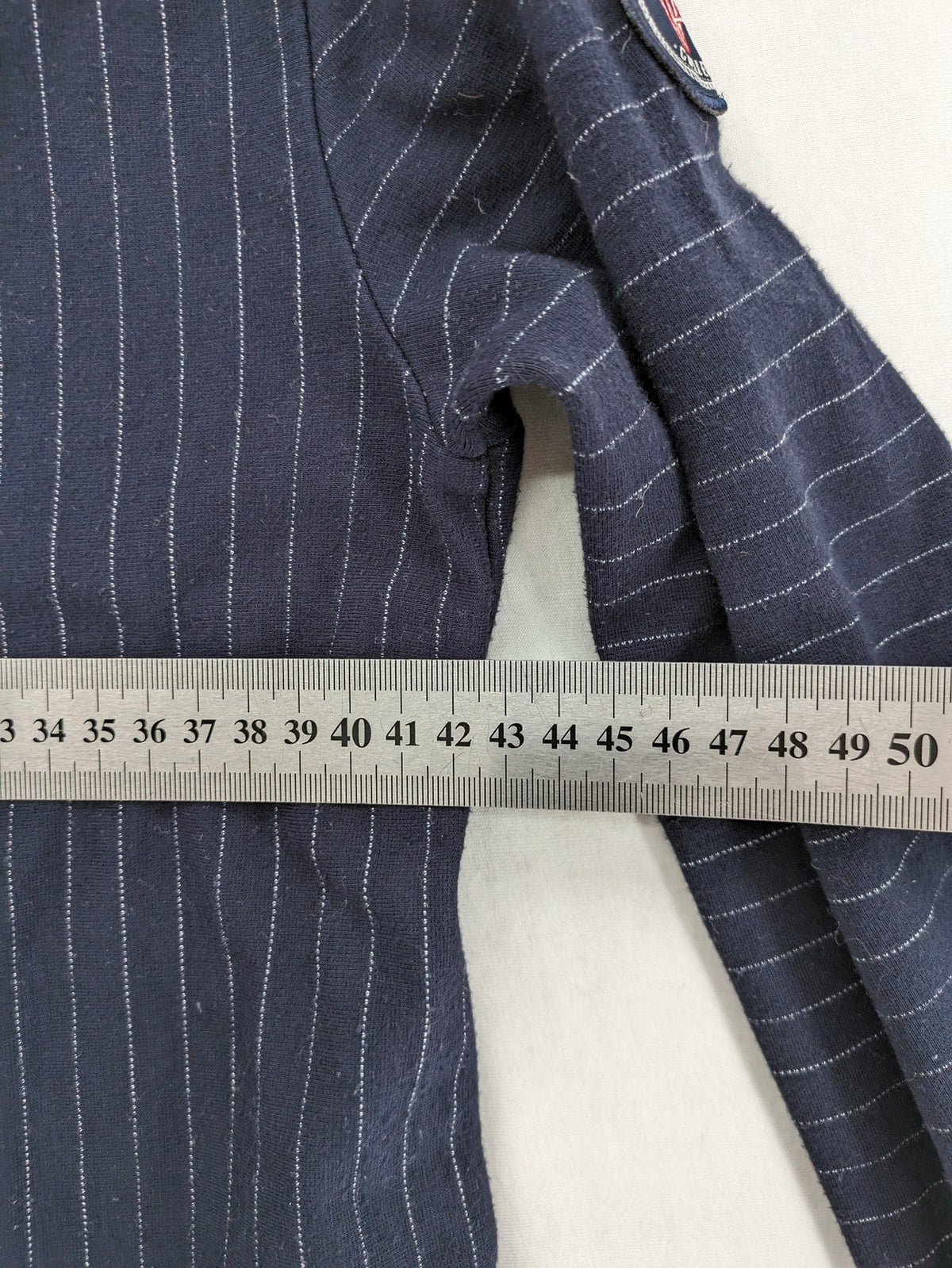 RIVER WOODS navy long sleeve top with white pinstripes and red "I AM très jolie" slogan.