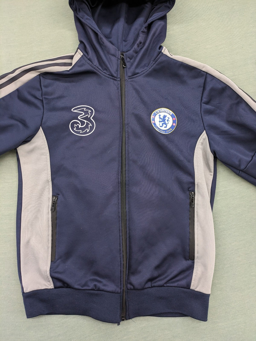 Chelsea FC grey and navy tracksuit set with full zip hoodie and three logos.