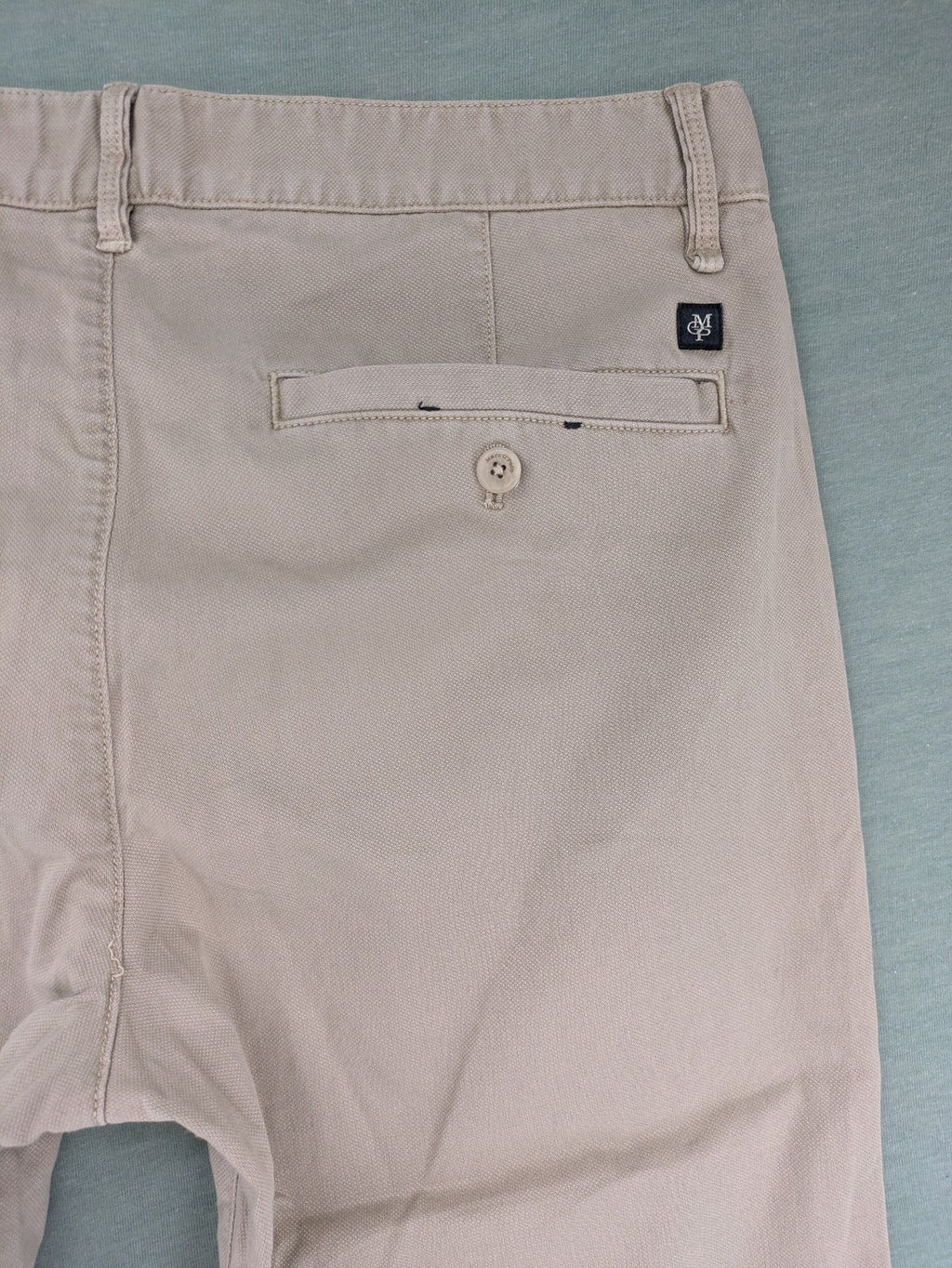 Marc O'Polo beige tapered fit chino pants, soft cotton stretch fabric, modern silhouette.