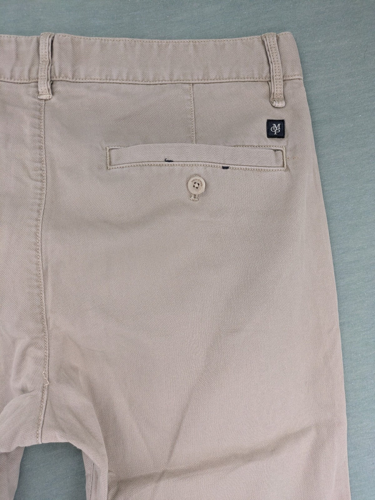 Marc O'Polo beige tapered fit chino pants, soft cotton stretch fabric, modern silhouette.