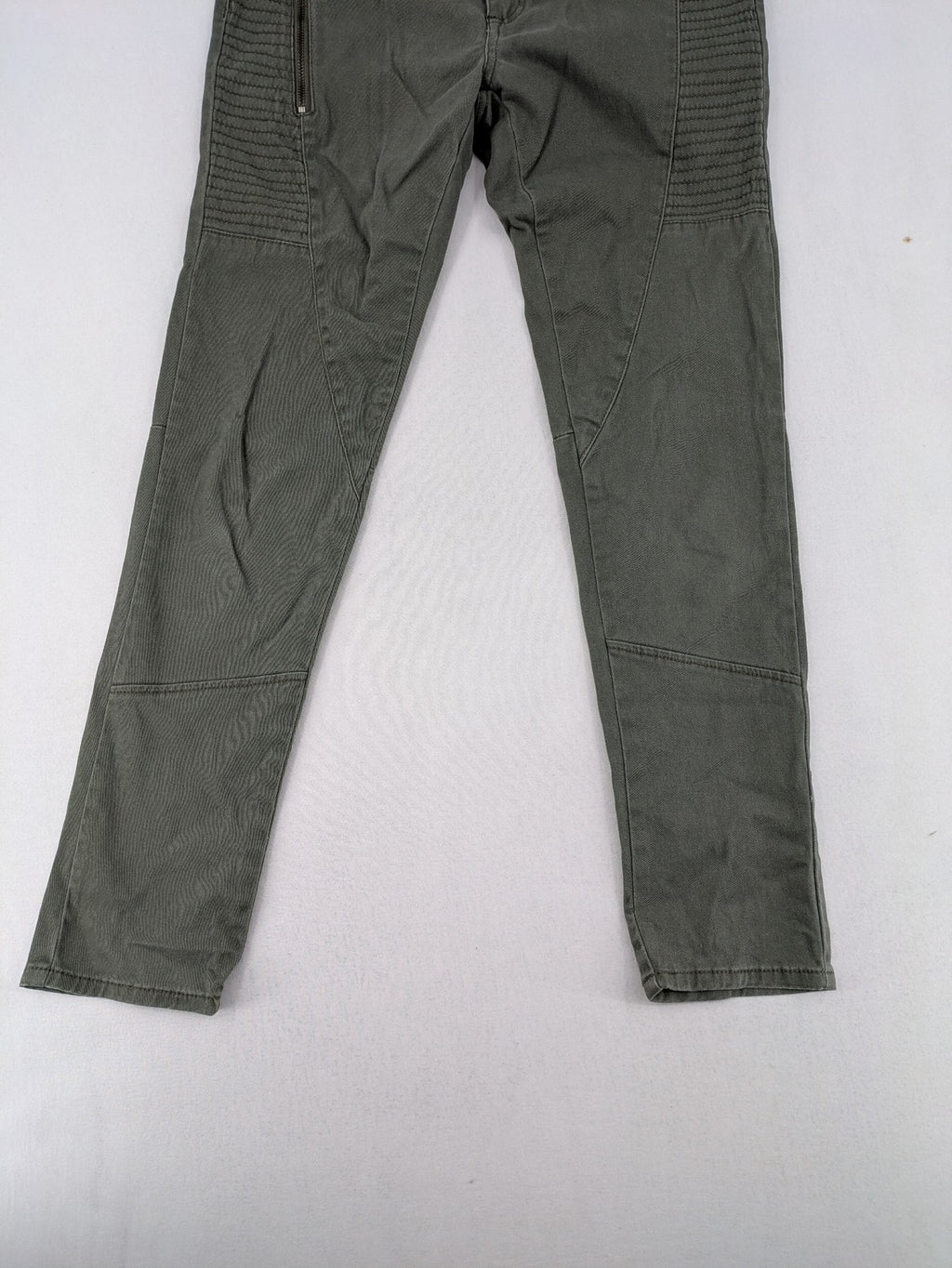 Page One Young khaki motorcycle pants with stitched panels and decorative zipper details.