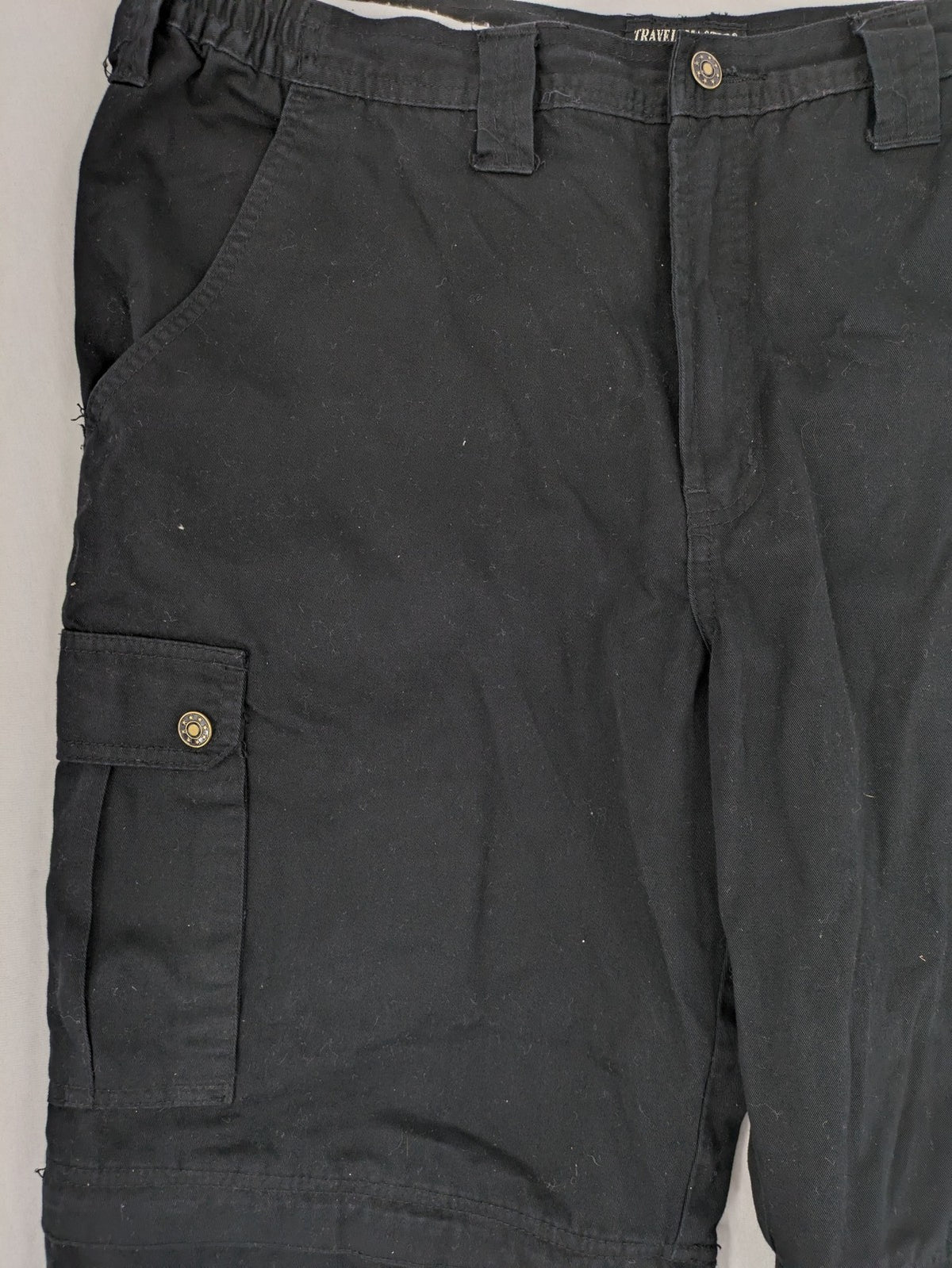 Travel Master black hunting and tactical pants, zip-off design, 100% cotton, multiple pockets.