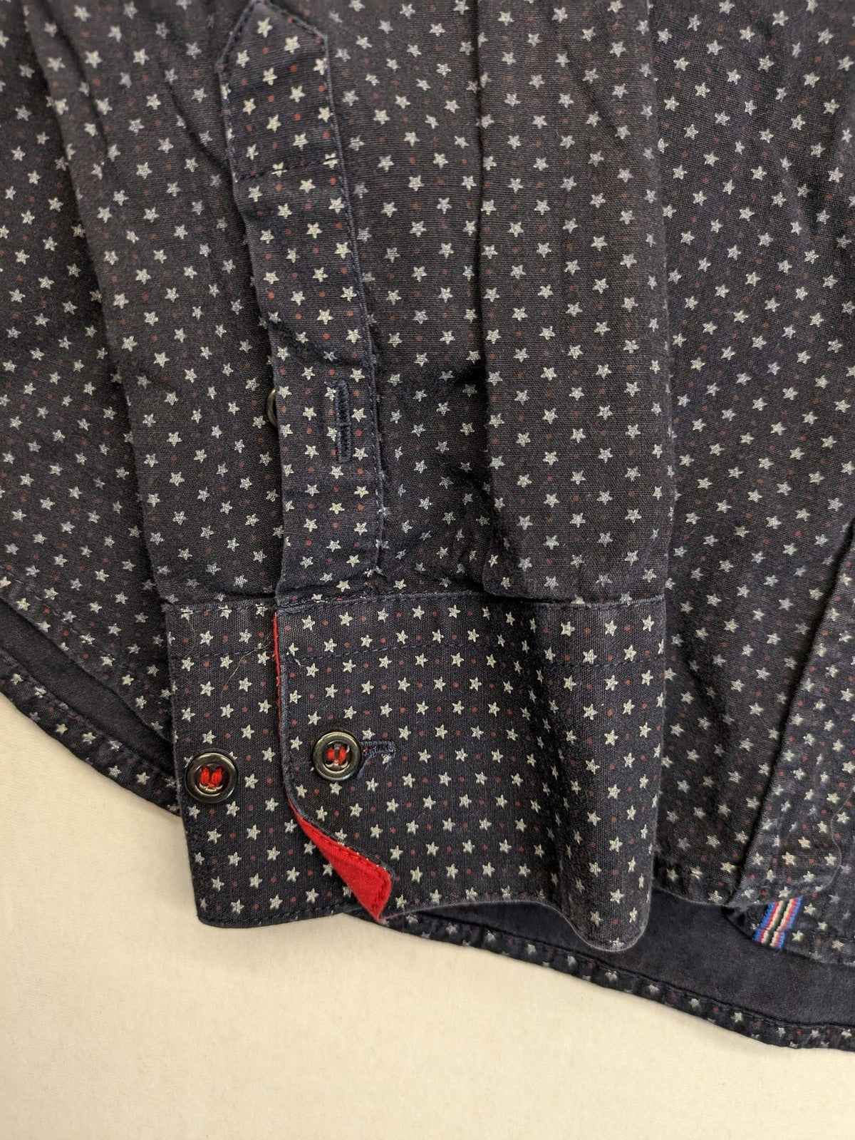 Tommy Hilfiger navy button-down shirt with white star pattern and embroidered flag logo.