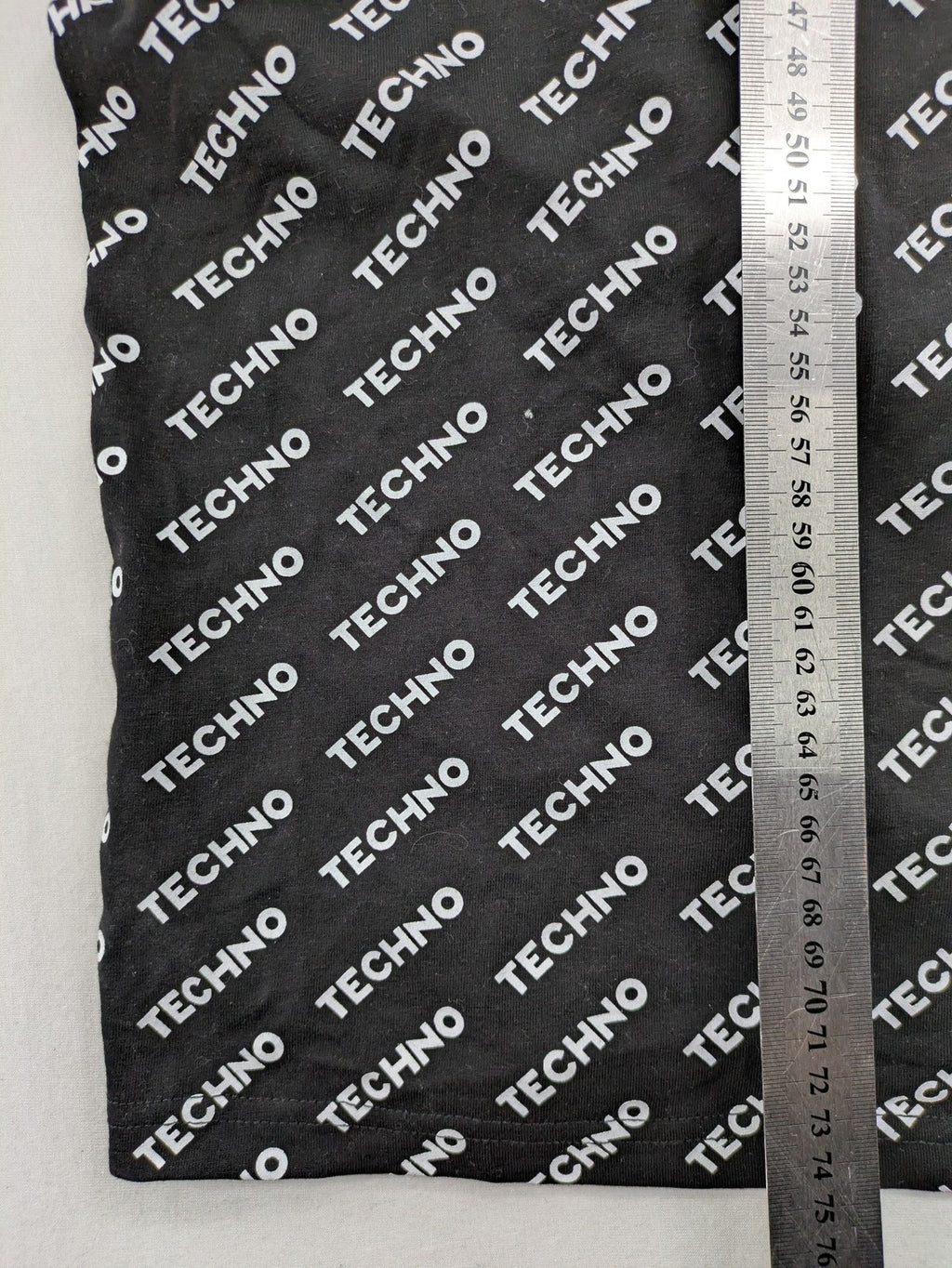 Fresh Cut black techno t-shirt all-over print with bold "TECHNO" graphic design.