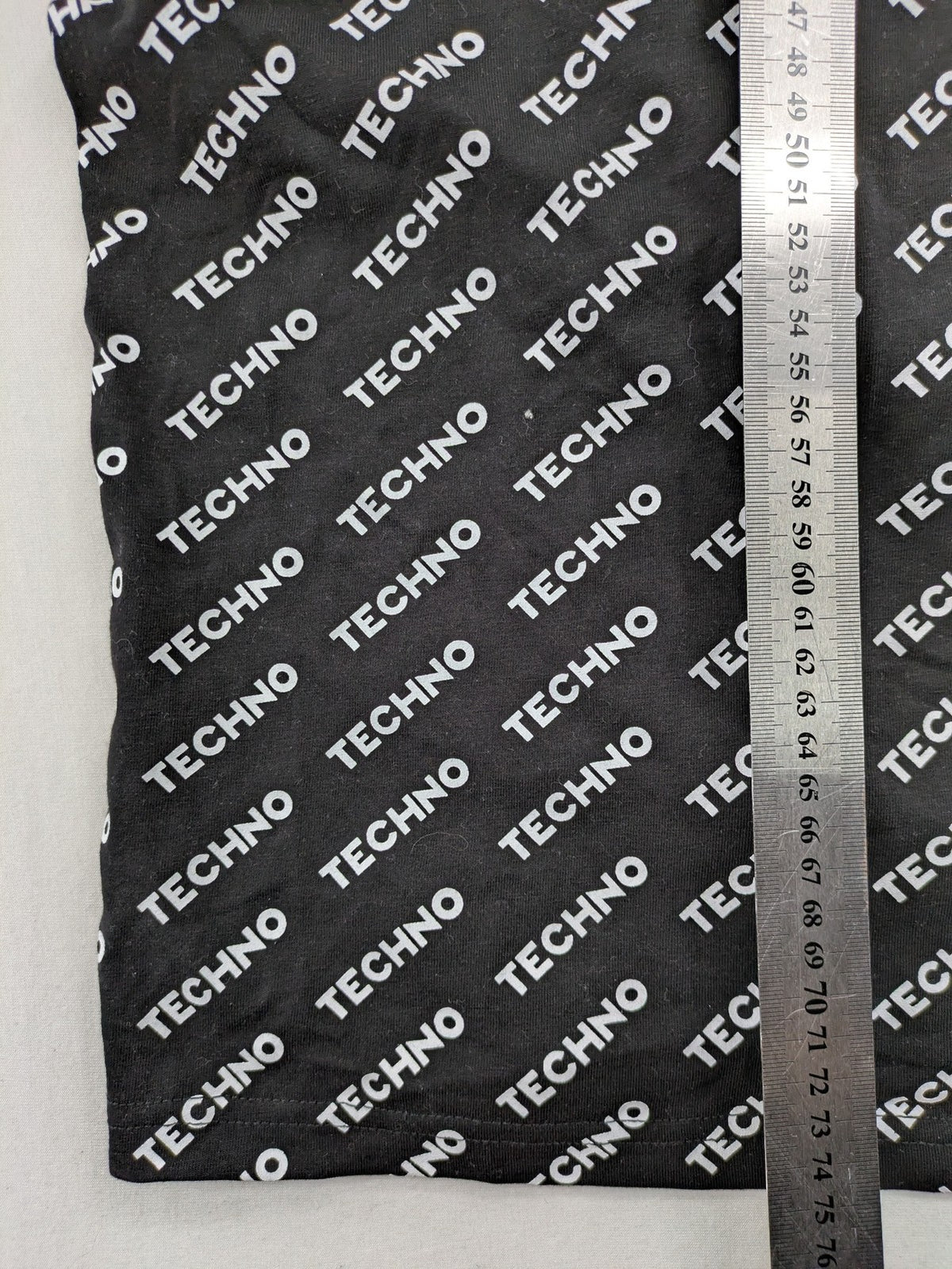 Fresh Cut black techno t-shirt all-over print with bold "TECHNO" graphic design.