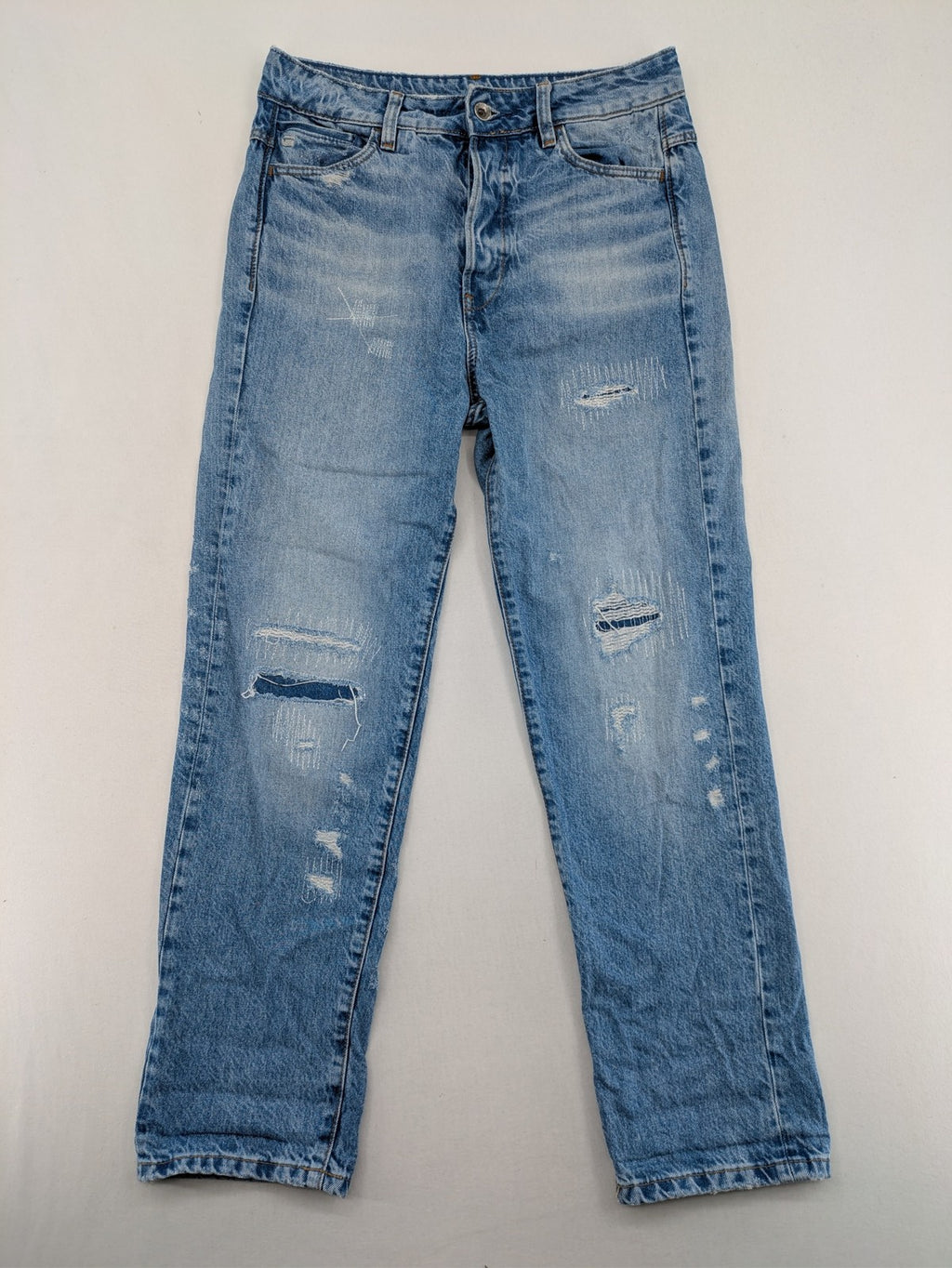 G-Star Raw blue distressed high boyfriend jeans with ripped details and classic button closure.