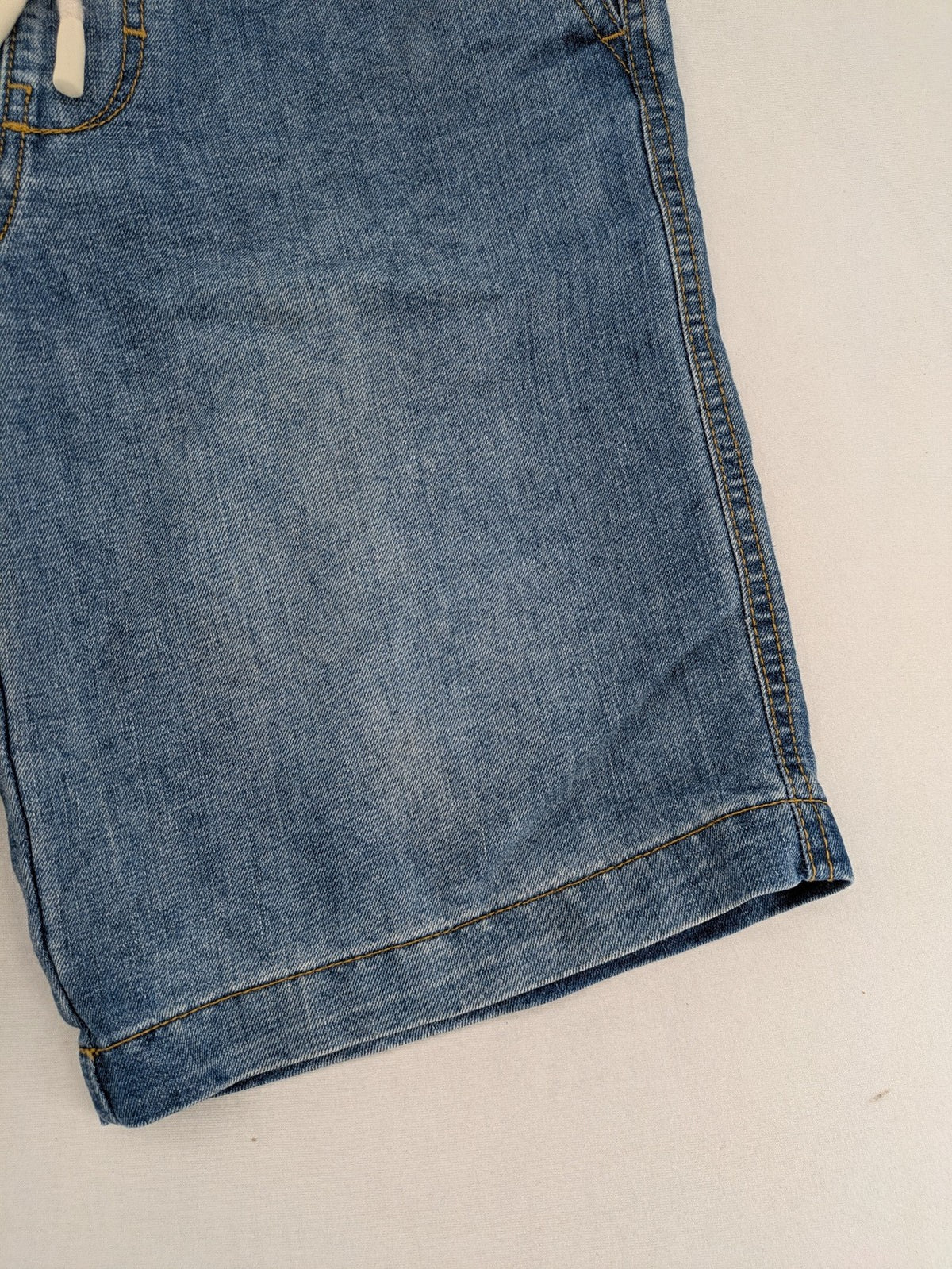 C&A blue denim shorts with elastic waistband and decorative drawstring, classic style.