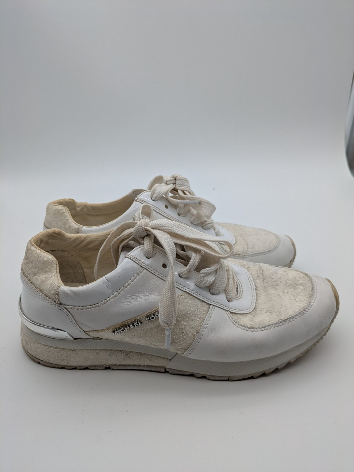 Michael Kors multi sneaker white leather and cream textile with silver logo details.