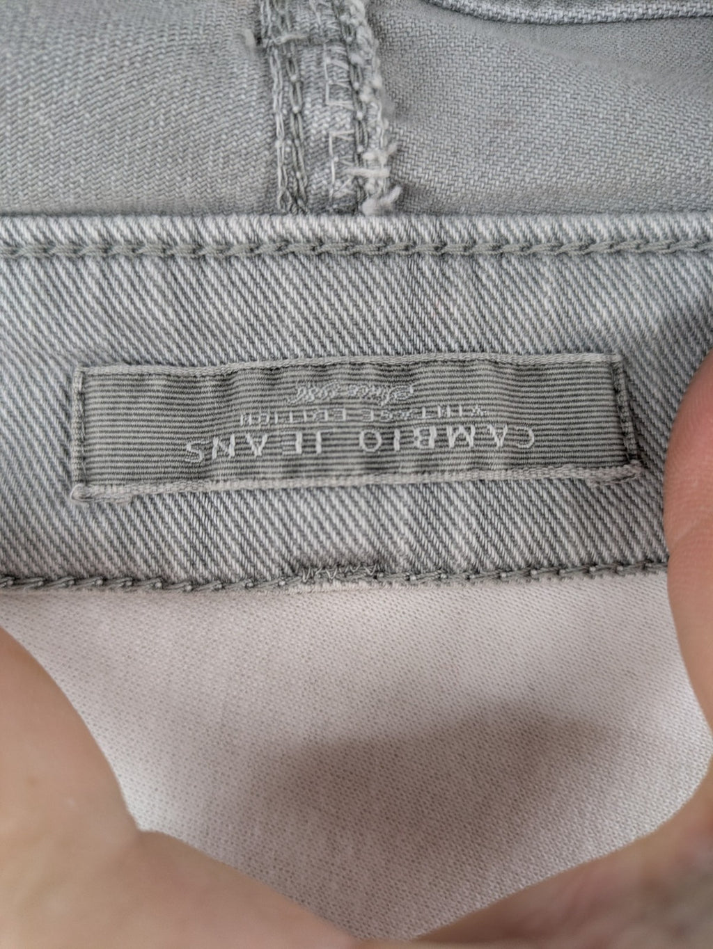 Cambio grey straight leg jeans with five-pocket design and logo button closure.