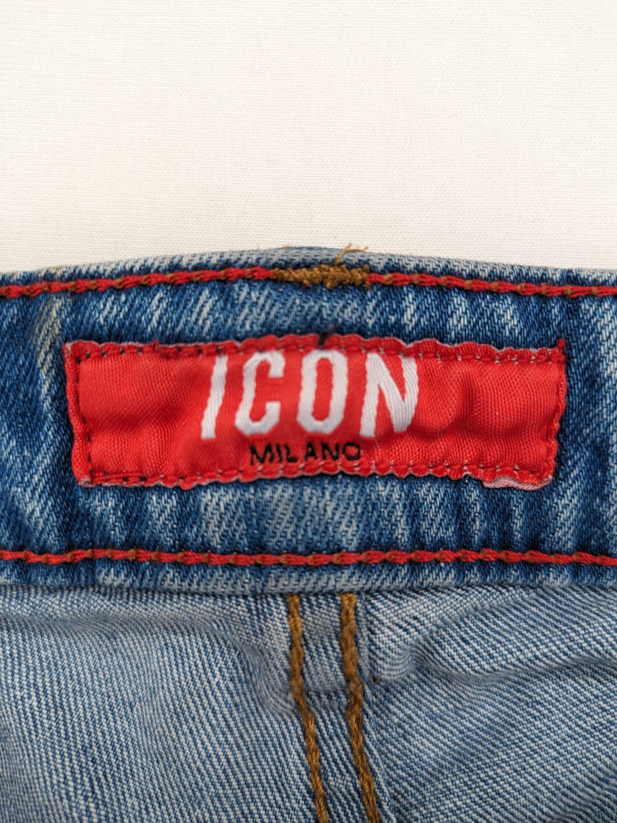 Milano straight jeans light blue distressed with red splatter and extra slim fit.