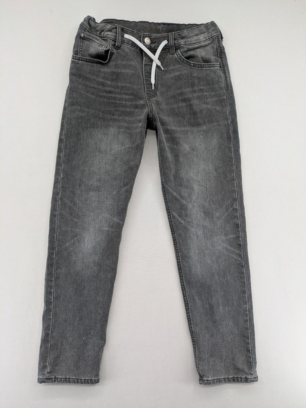 H&M grey jogger jeans with elastic waistband and drawstring, stylish washed look.