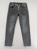 H&M grey jogger jeans with elastic waistband and drawstring, stylish washed look.