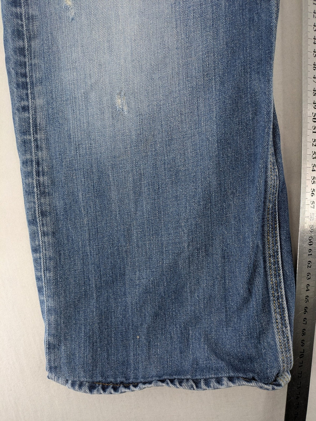 G-Star Raw blue straight jeans with distressed details and classic button fly.