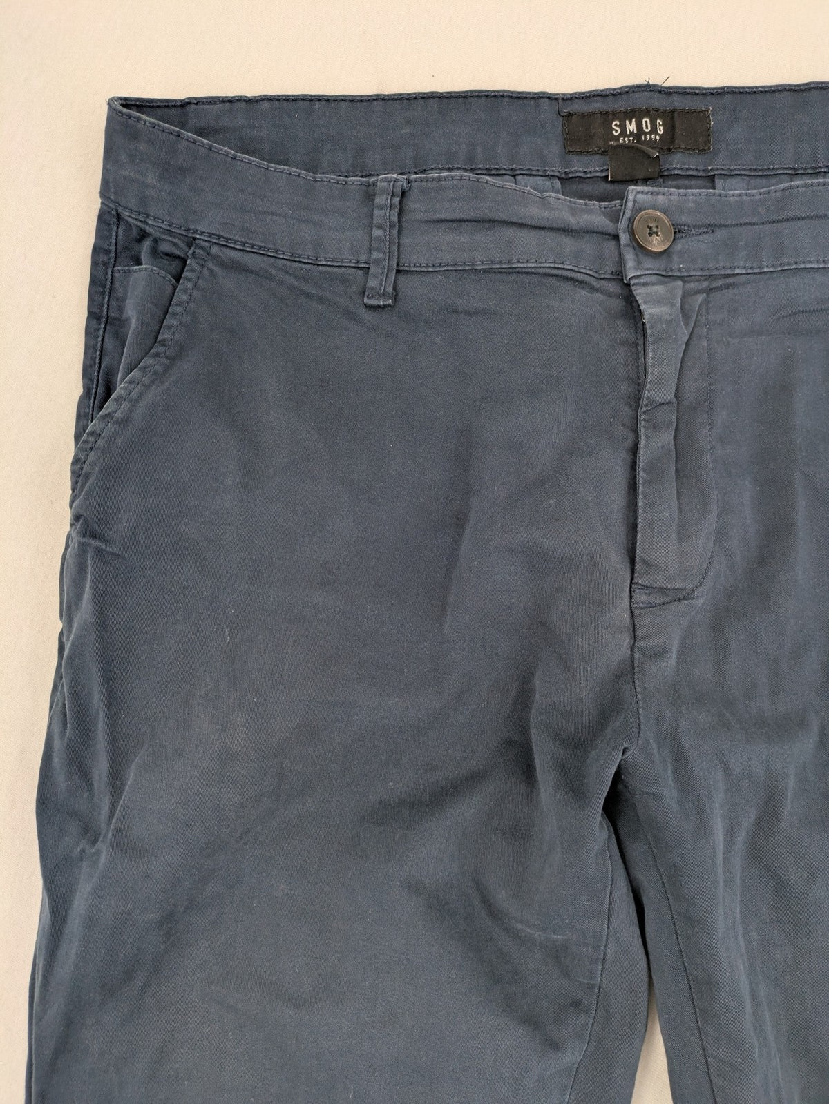 smog blue chino pants with belt loops, button fly, and side pockets
