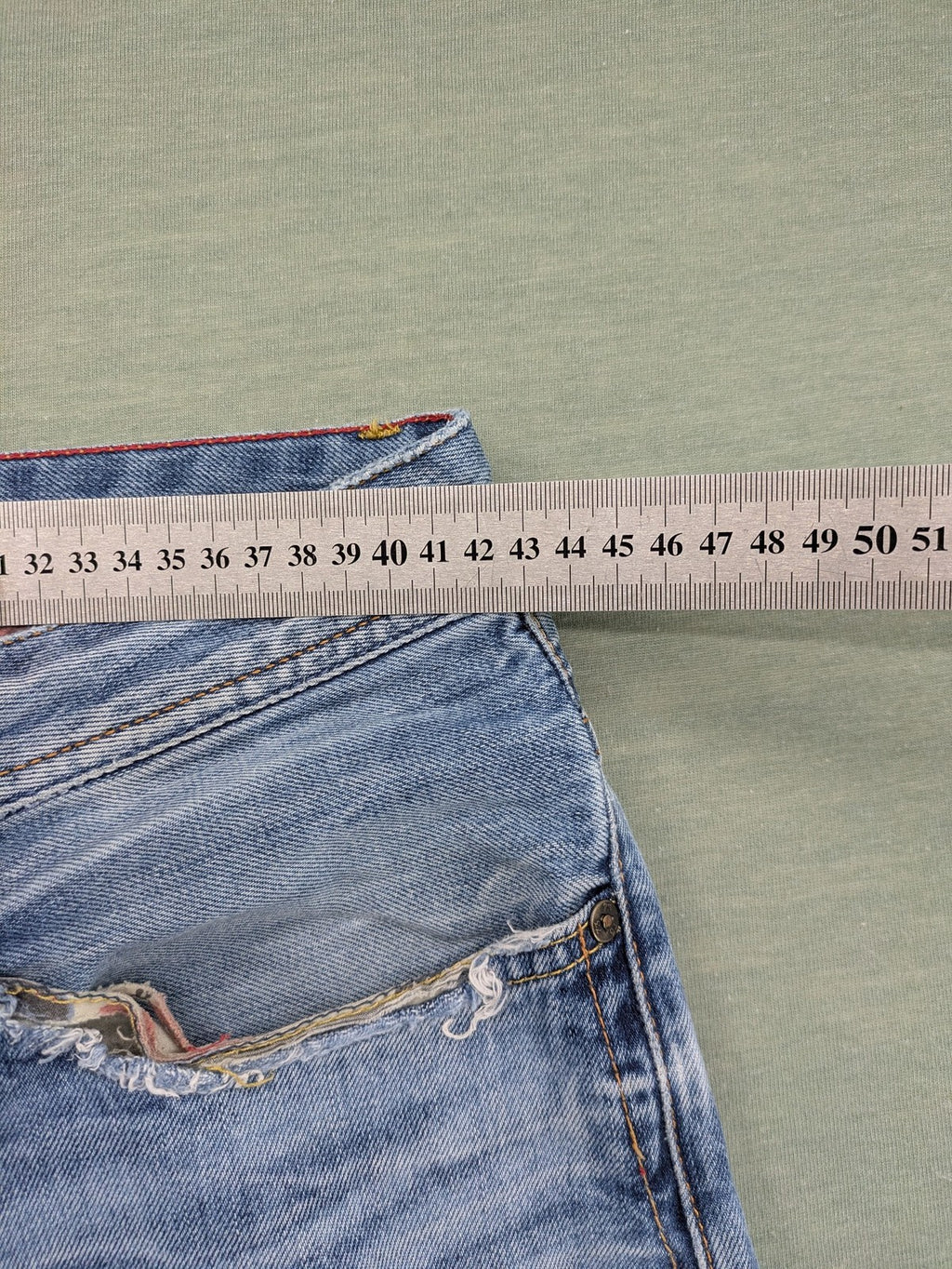 Pepe Jeans blue straight jeans with Union Jack embroidery and distressed denim finish.