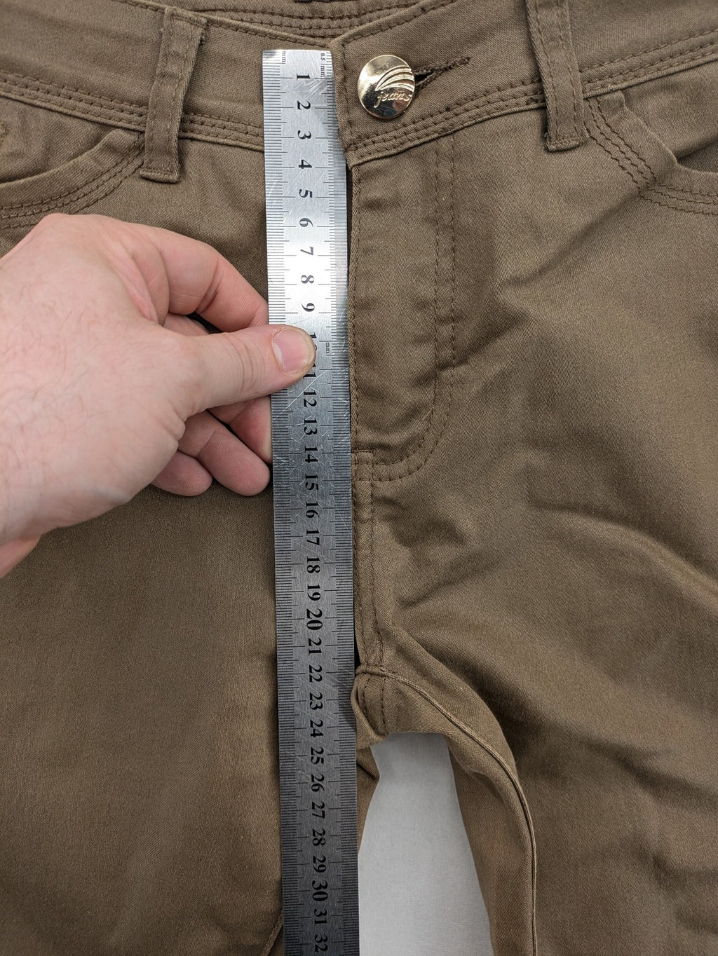 Vavell khaki skinny jeans five-pocket design with unique front zipper detail.