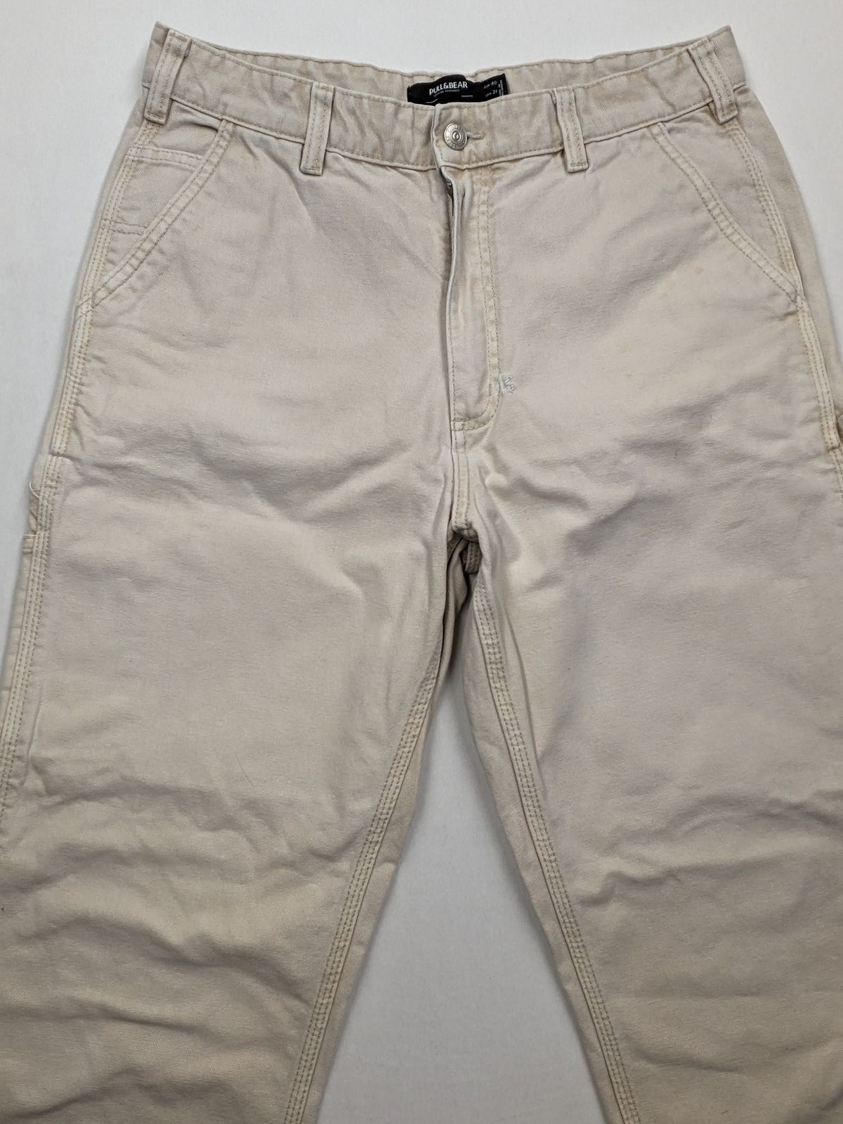 Pull&Bear beige carpenter pants with classic zipper, belt loops, and durable cotton material.