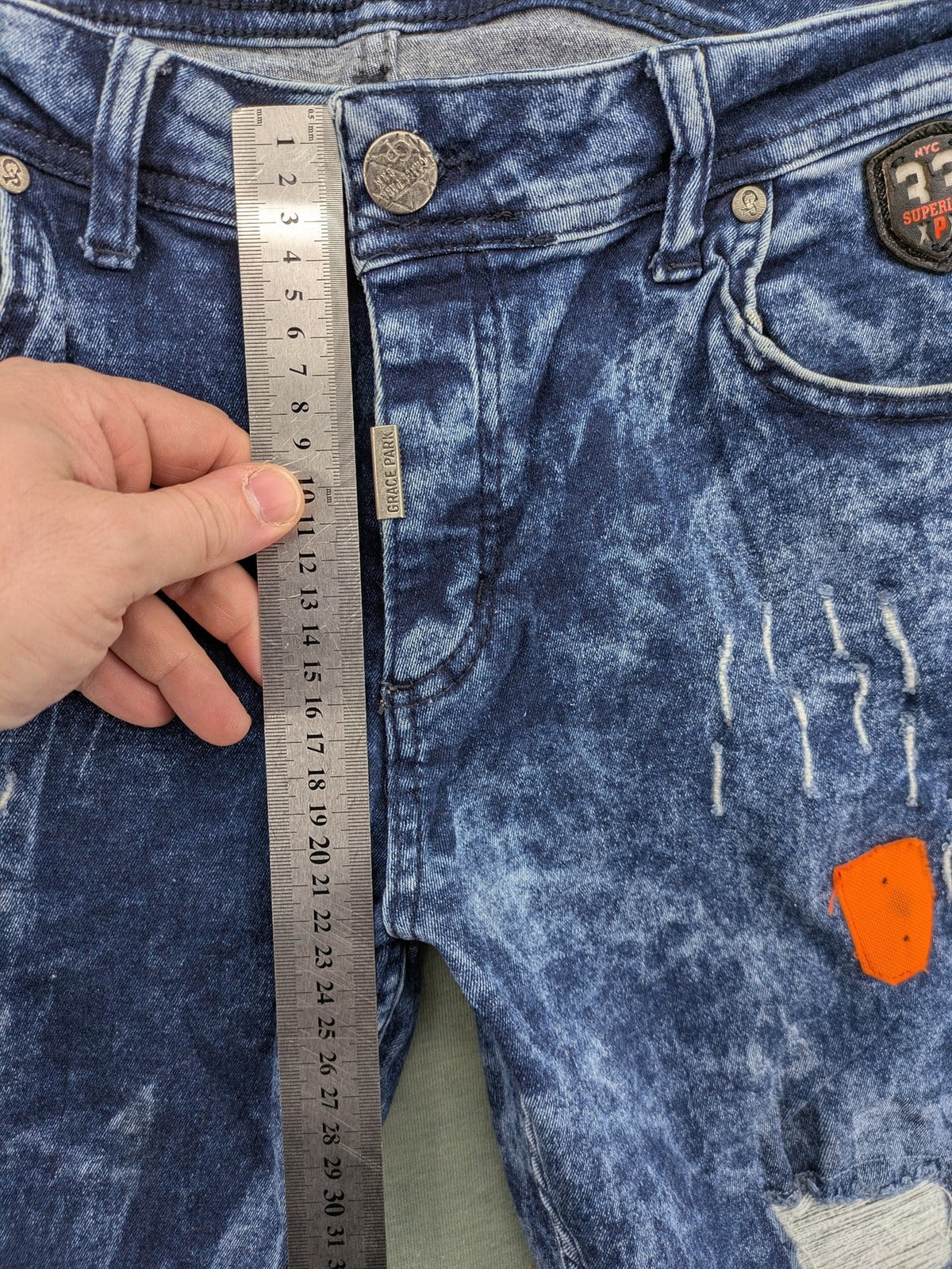 Stark straight jeans multi distressed acid wash with orange patches and side stripes.
