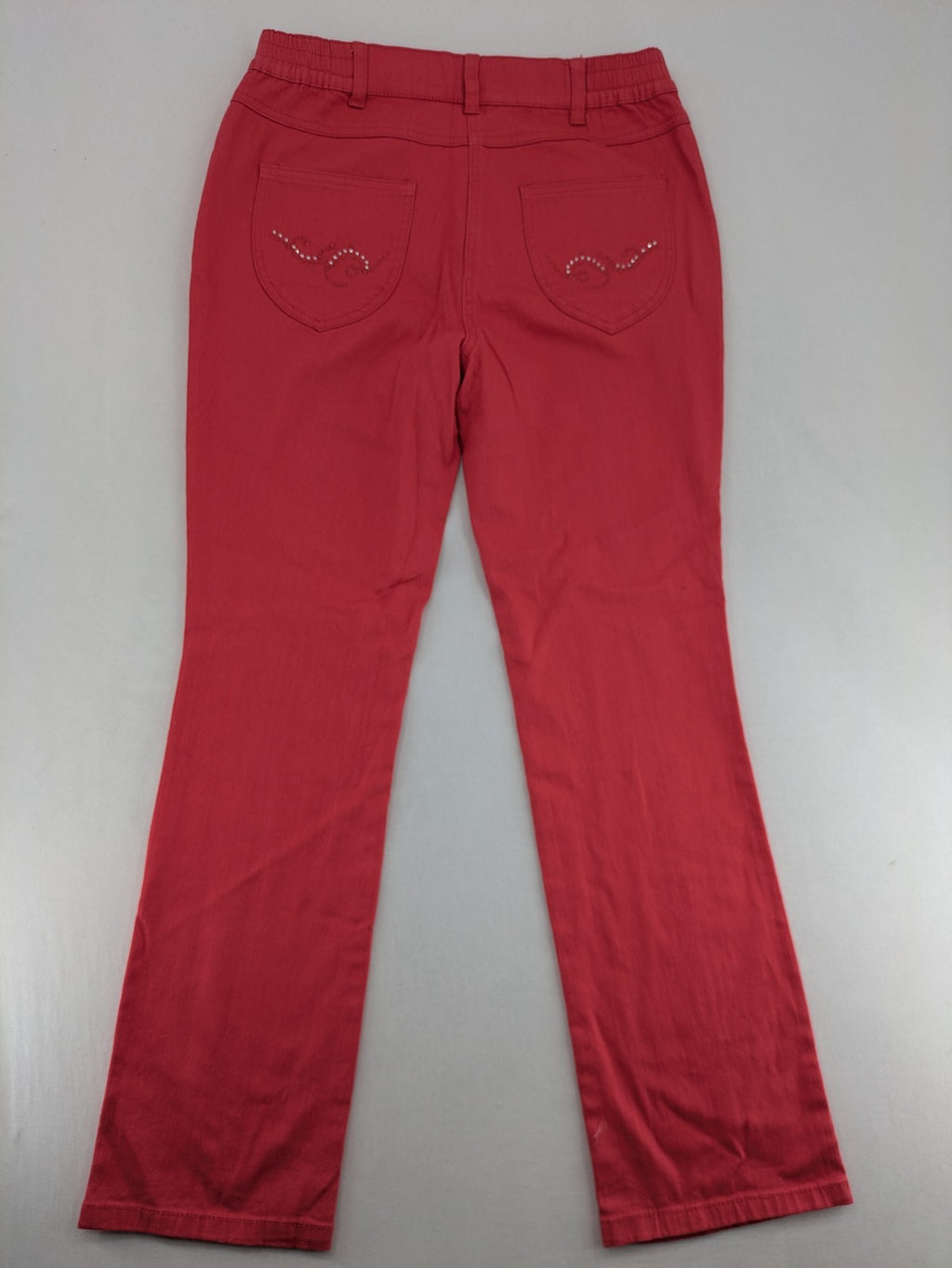 Helena Vera red straight jeans with elastic waistband and rhinestone details on pockets.