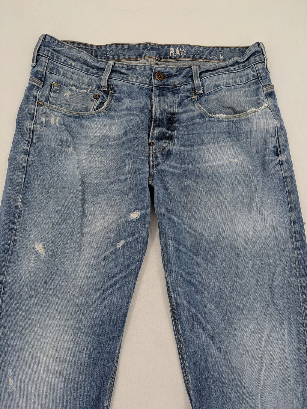 G-Star Raw blue straight jeans with distressed details and classic button fly.
