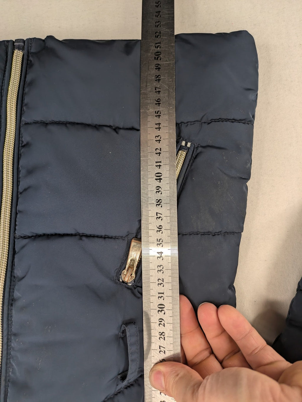 GEF cream coat with quilted design, fleece-lined hood, and faux fur trim.