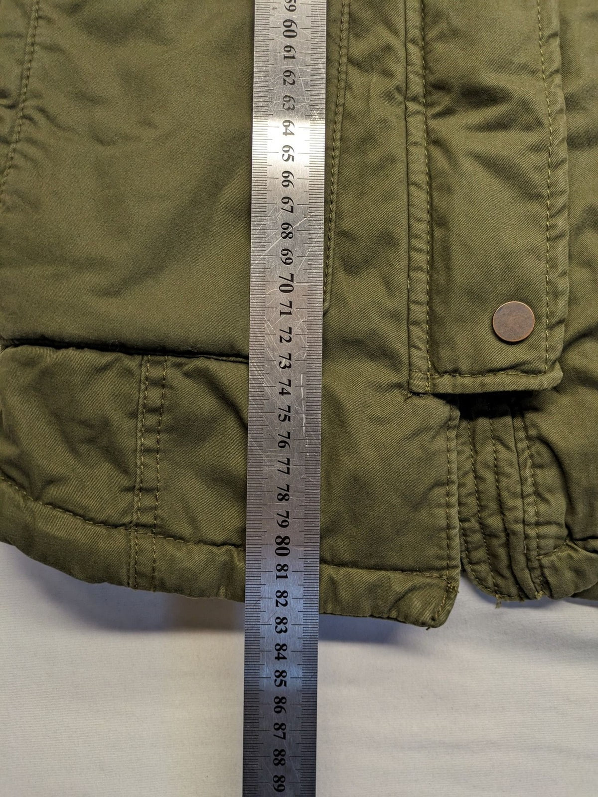 Vp Fashion khaki parka coat with "Bloomin' Lovely" floral embroidery and quilted lining.