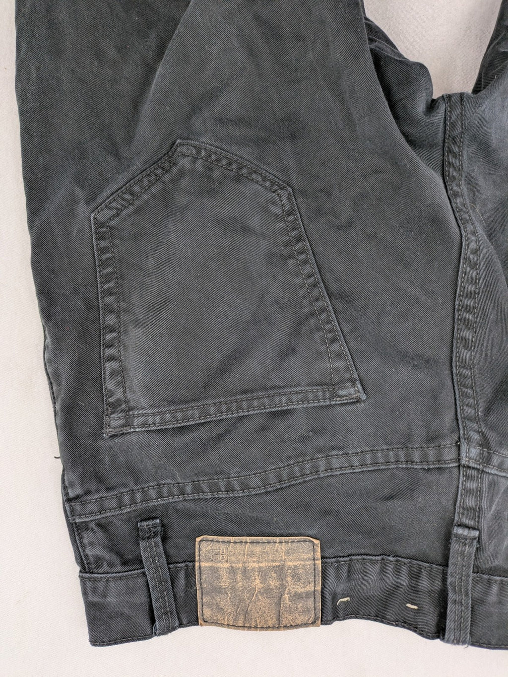 Ckh grey straight fit jeans with button fly and faded wash details.