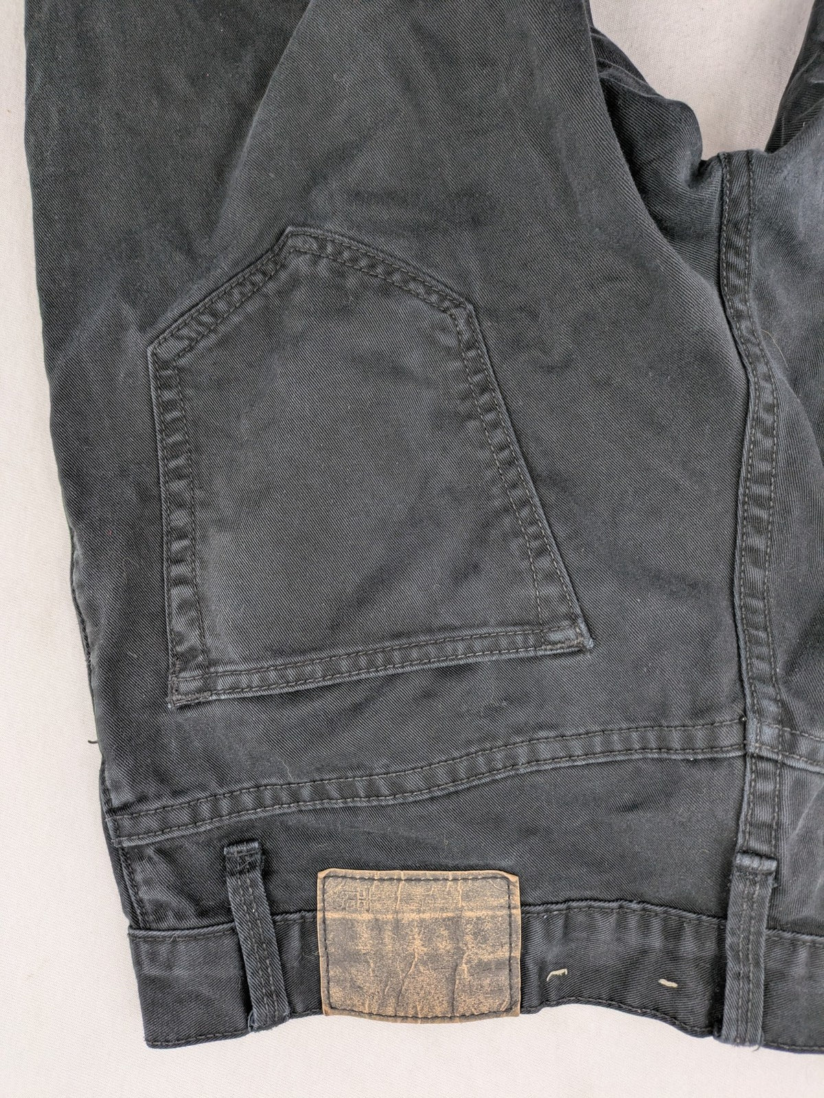 Ckh grey straight fit jeans with button fly and faded wash details.
