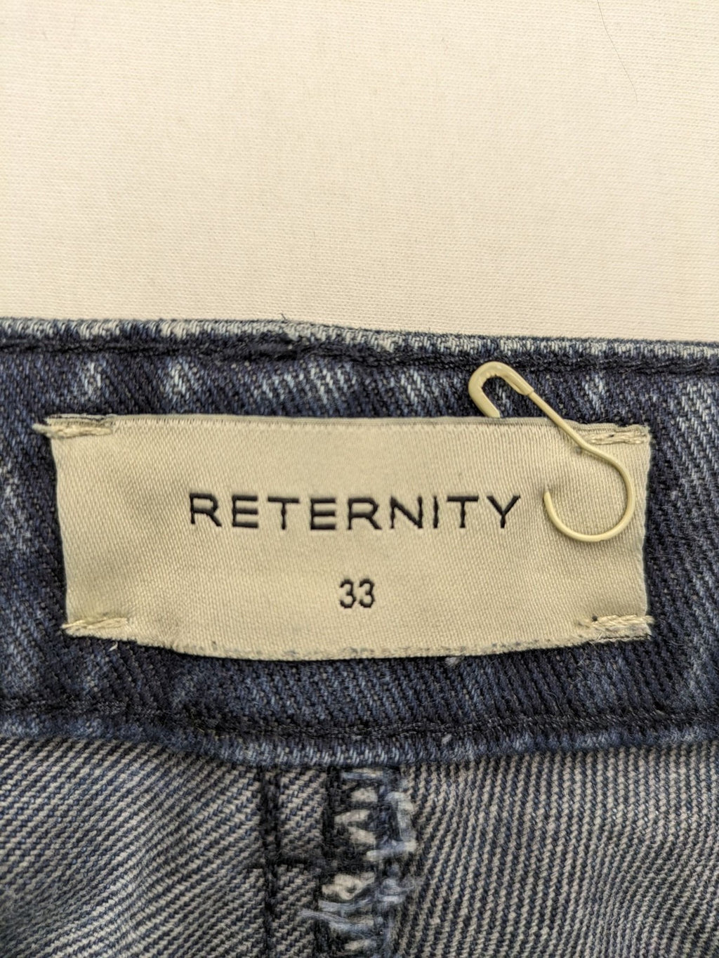 Reternity straight jeans blue black patchwork design with distressed details and frayed seams.