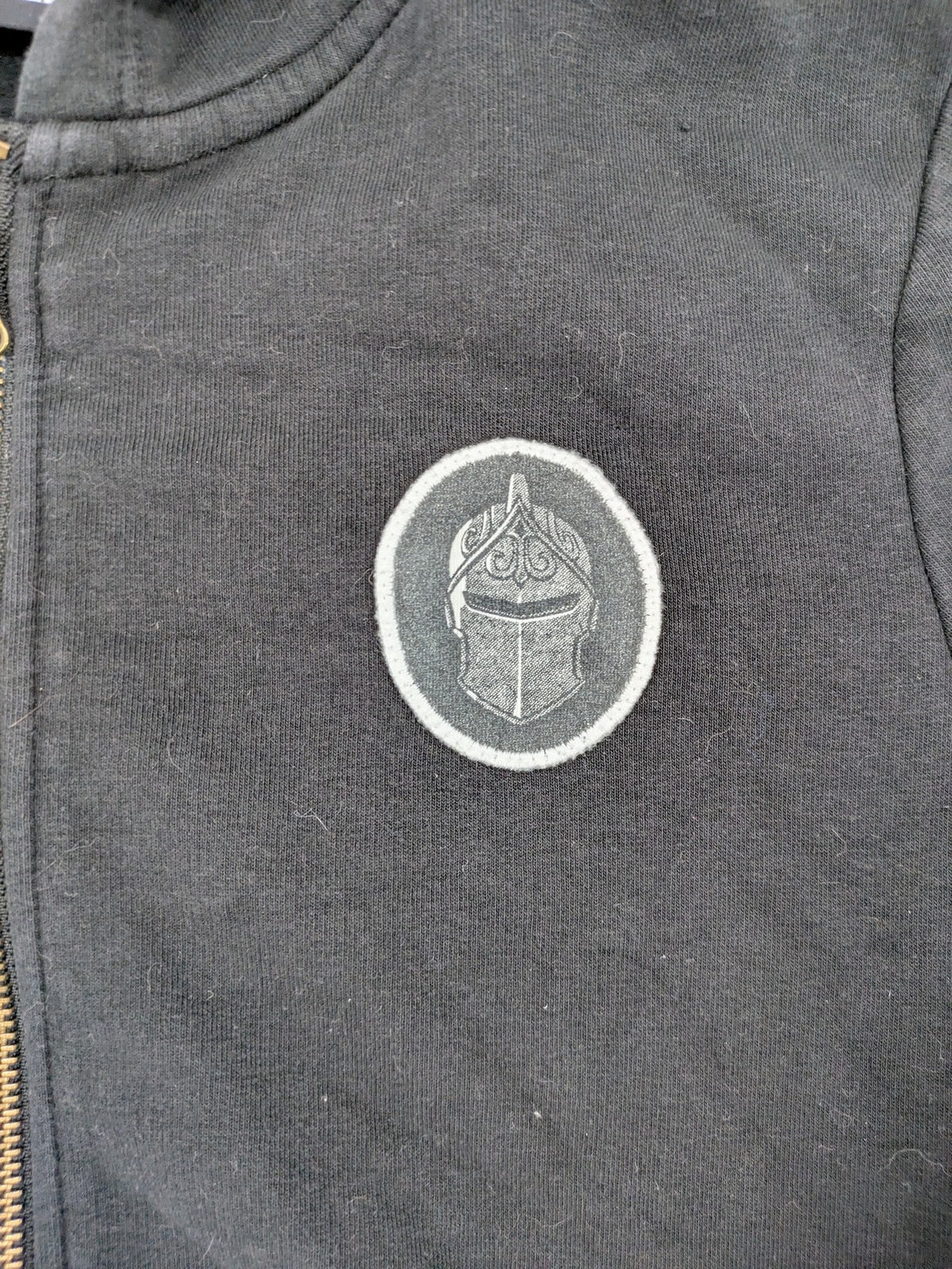 Fortnite black zip-through hoodie with logo on sleeves and Black Knight patch on chest.