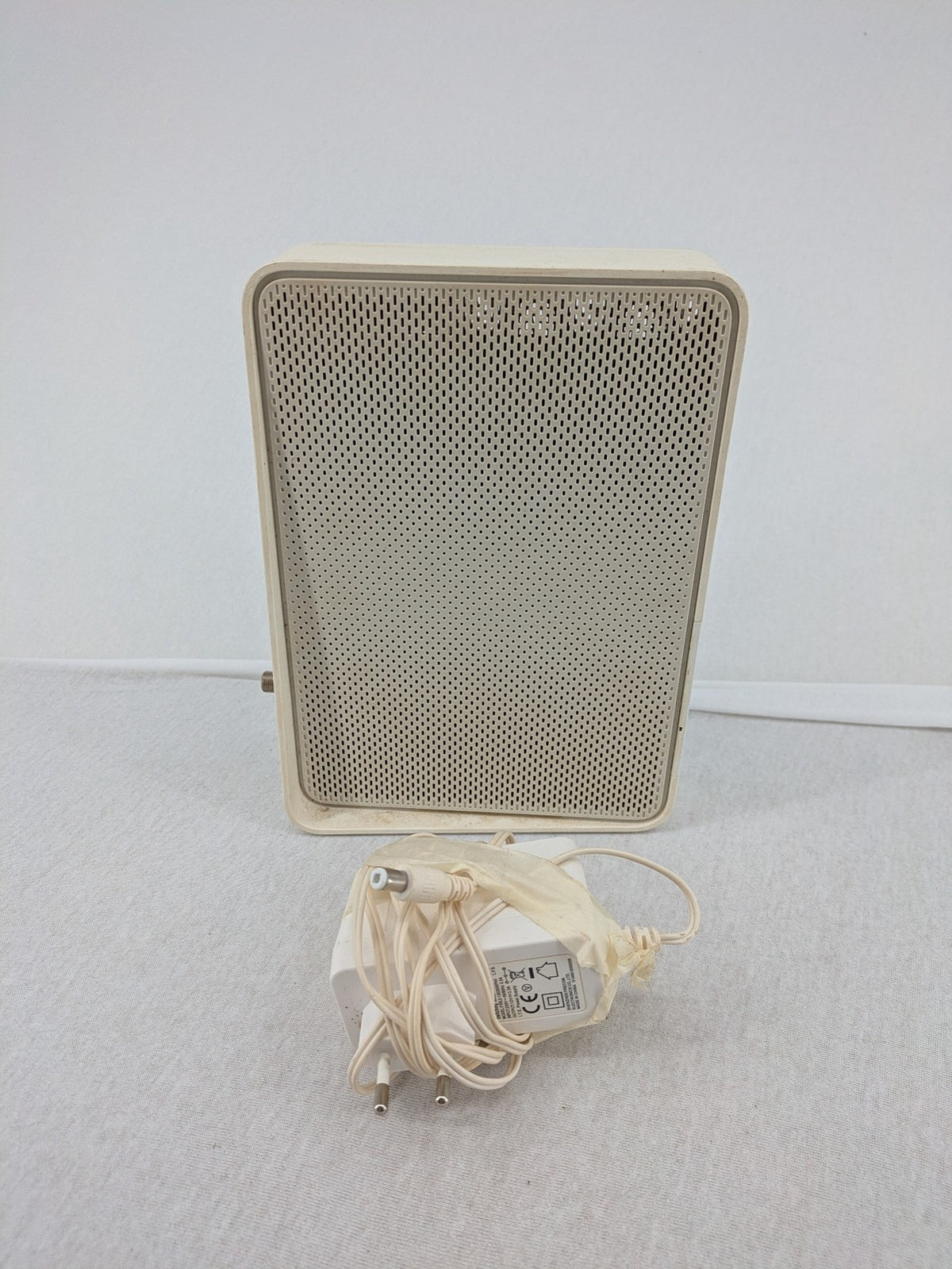 Compal beige WLAN modem router with integrated Wi-Fi and multiple LAN ports.