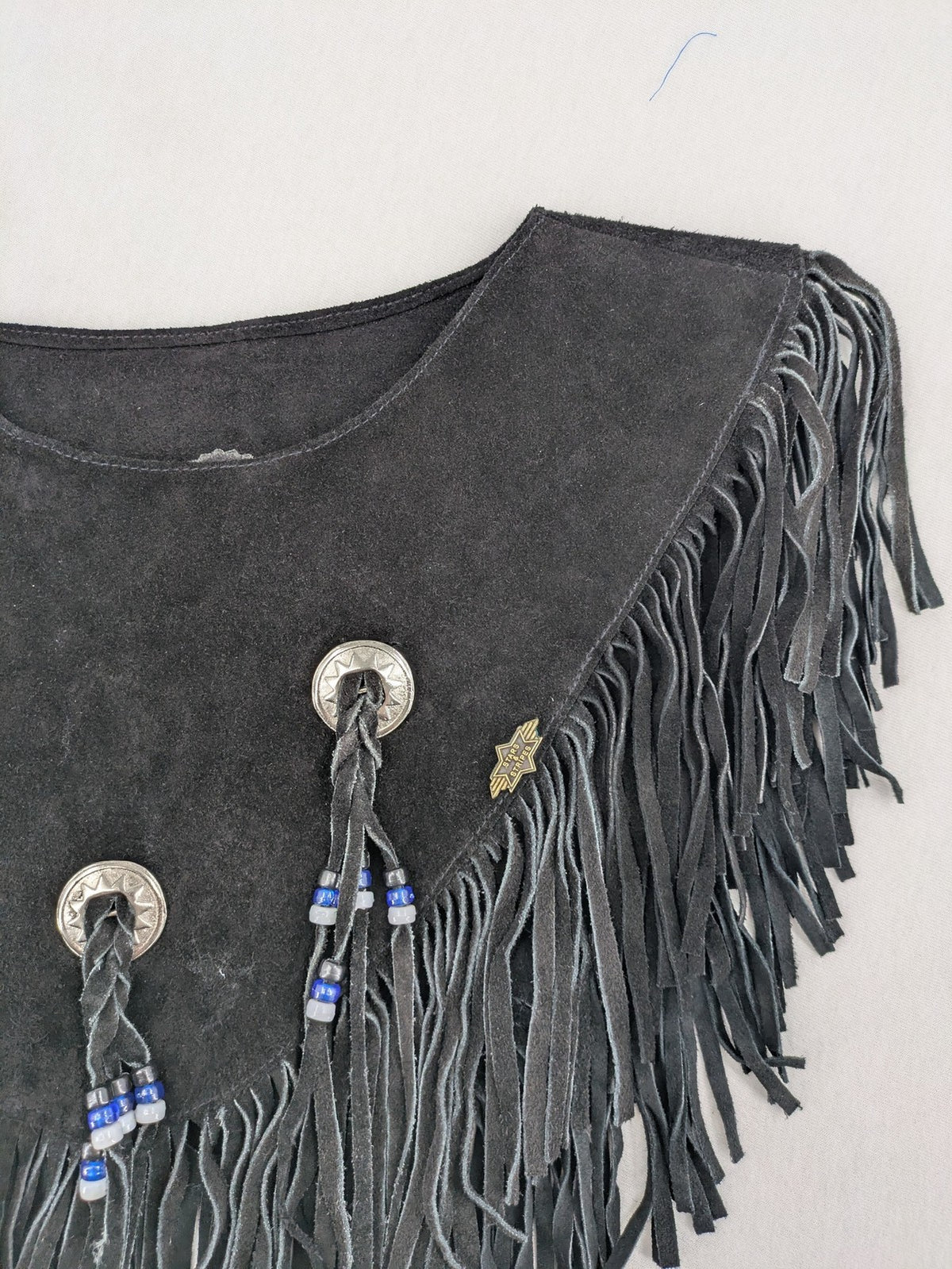 Stars & Stripes black suede fringe vest with silver conchos and beaded tassels.