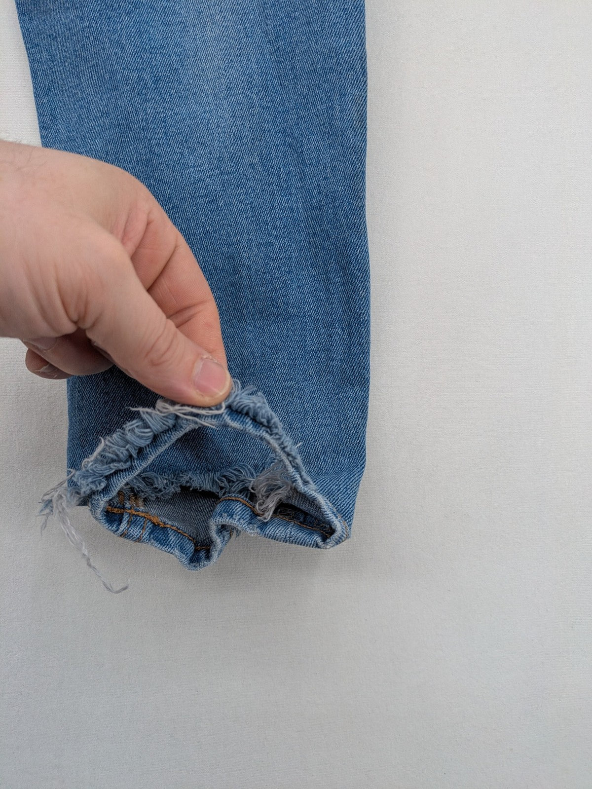 Pull&Bear blue carrot fit jeans with distressed knees and frayed hems.