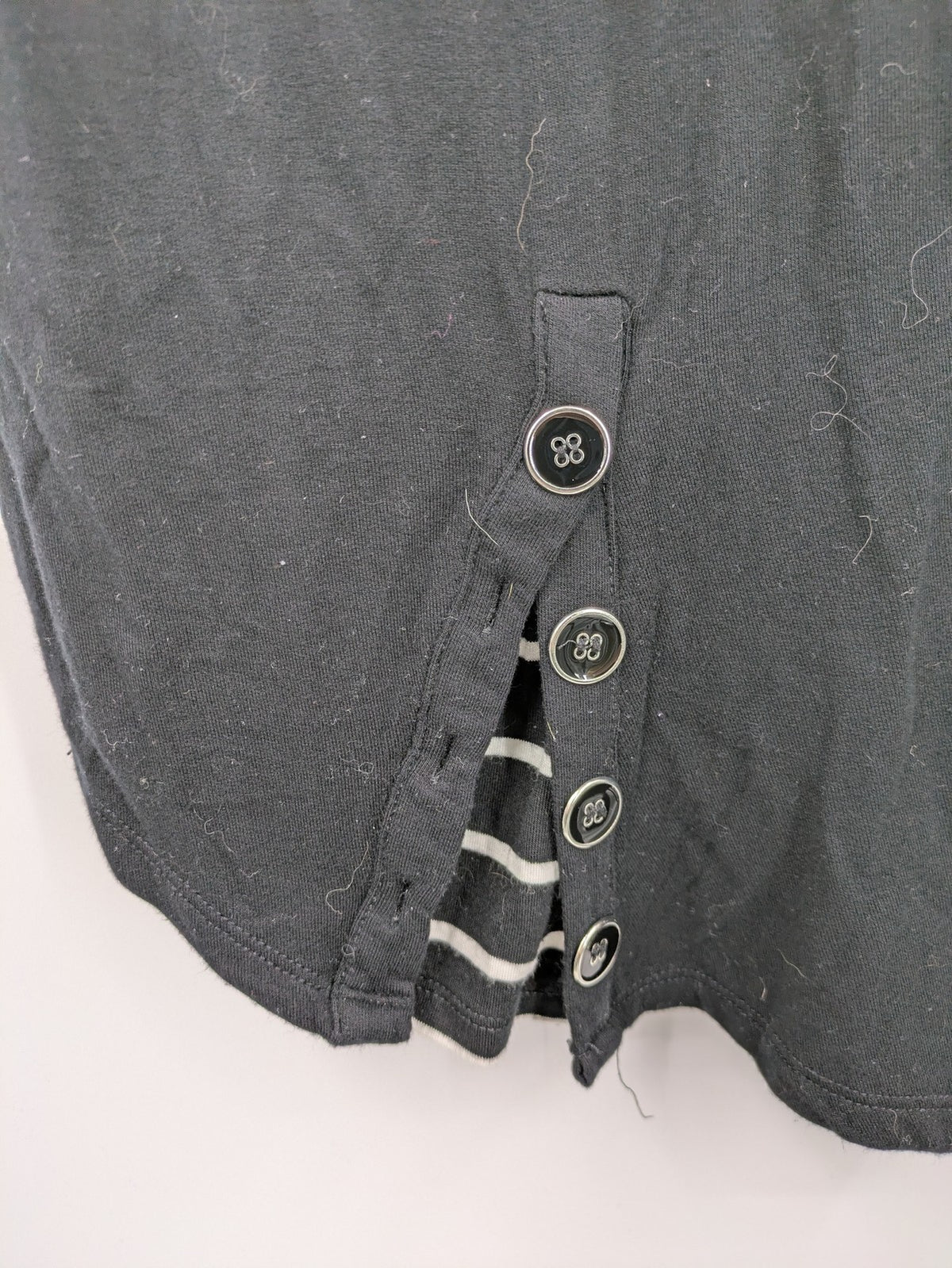 Cupio black long sleeve tunic with side button placket and high-low hem.