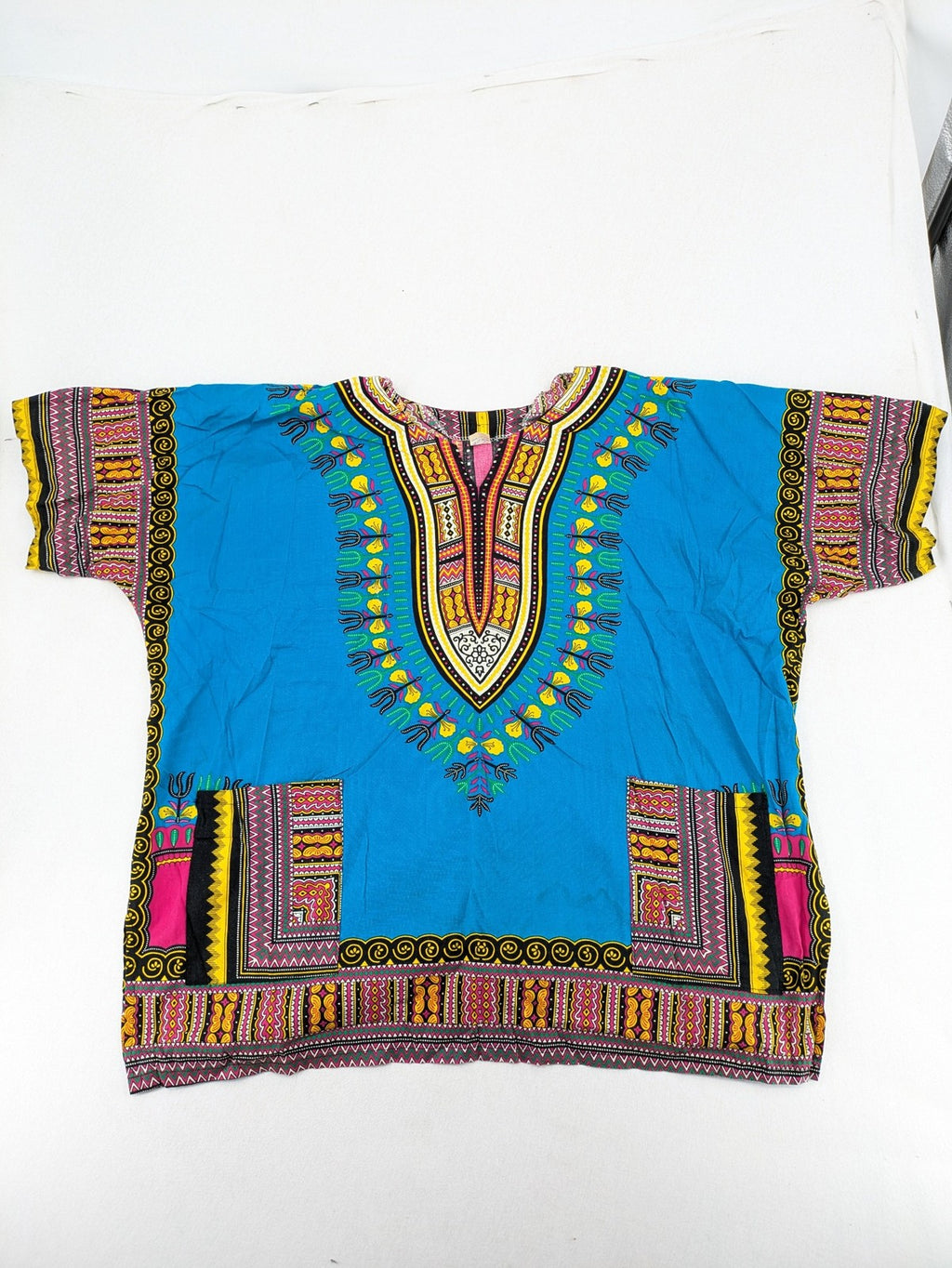 M/L multi Dashiki shirt with vibrant ethnic print on light blue cotton fabric.