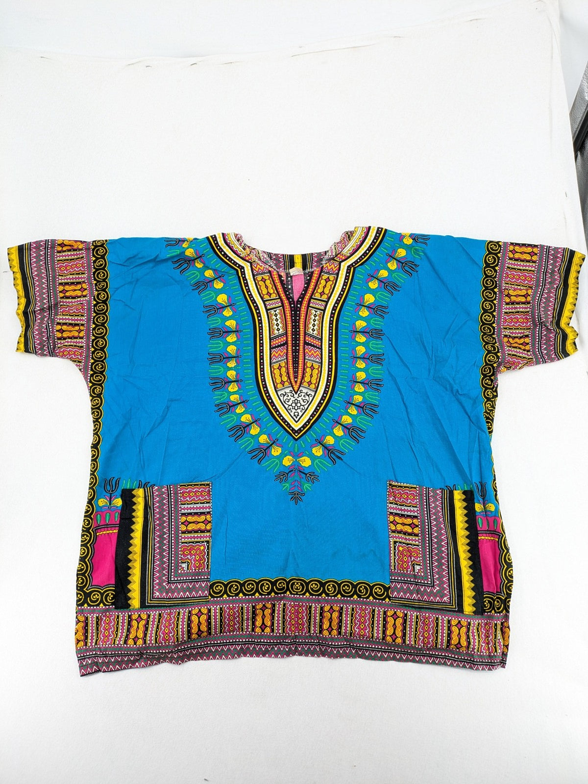 M/L multi Dashiki shirt with vibrant ethnic print on light blue cotton fabric.