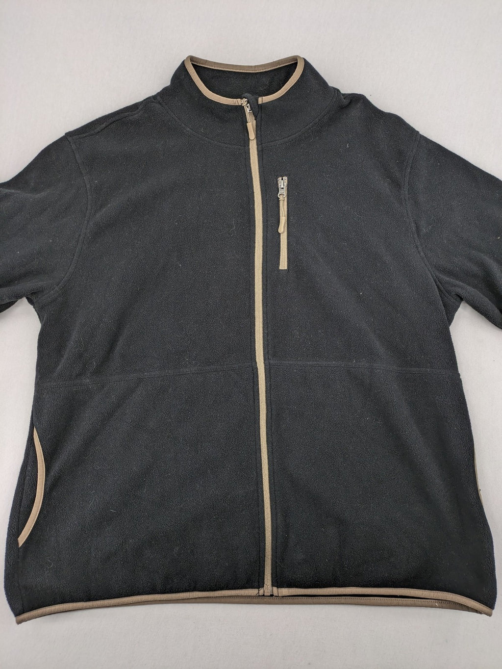 Crane beige and black fleece jacket full zip with cream accents and zippered pockets.