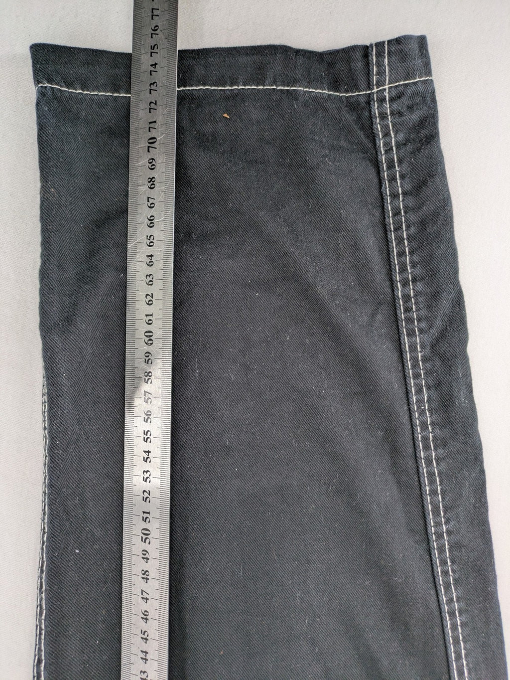 FSBN black baggy cargo pants with white contrast stitching and multiple pockets.