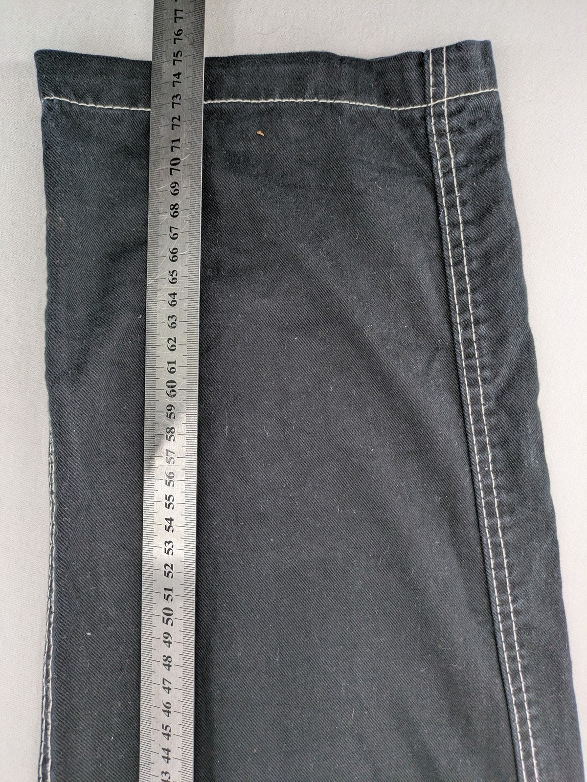 FSBN black baggy cargo pants with white contrast stitching and multiple pockets.