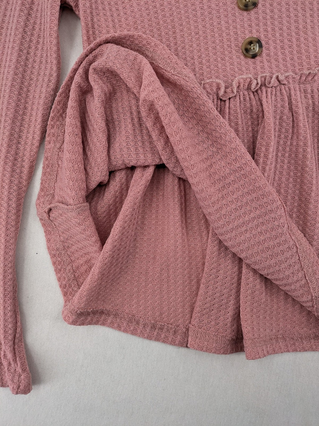 SHEIN pink top V-neck with ruffled waist and three decorative buttons, waffle knit fabric.